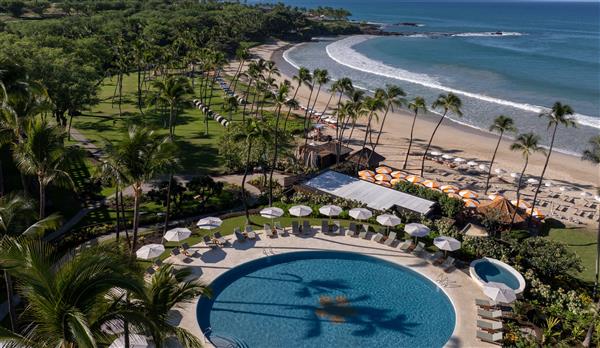 Family Pool aerial with yellow beach umbrellas and palm trees