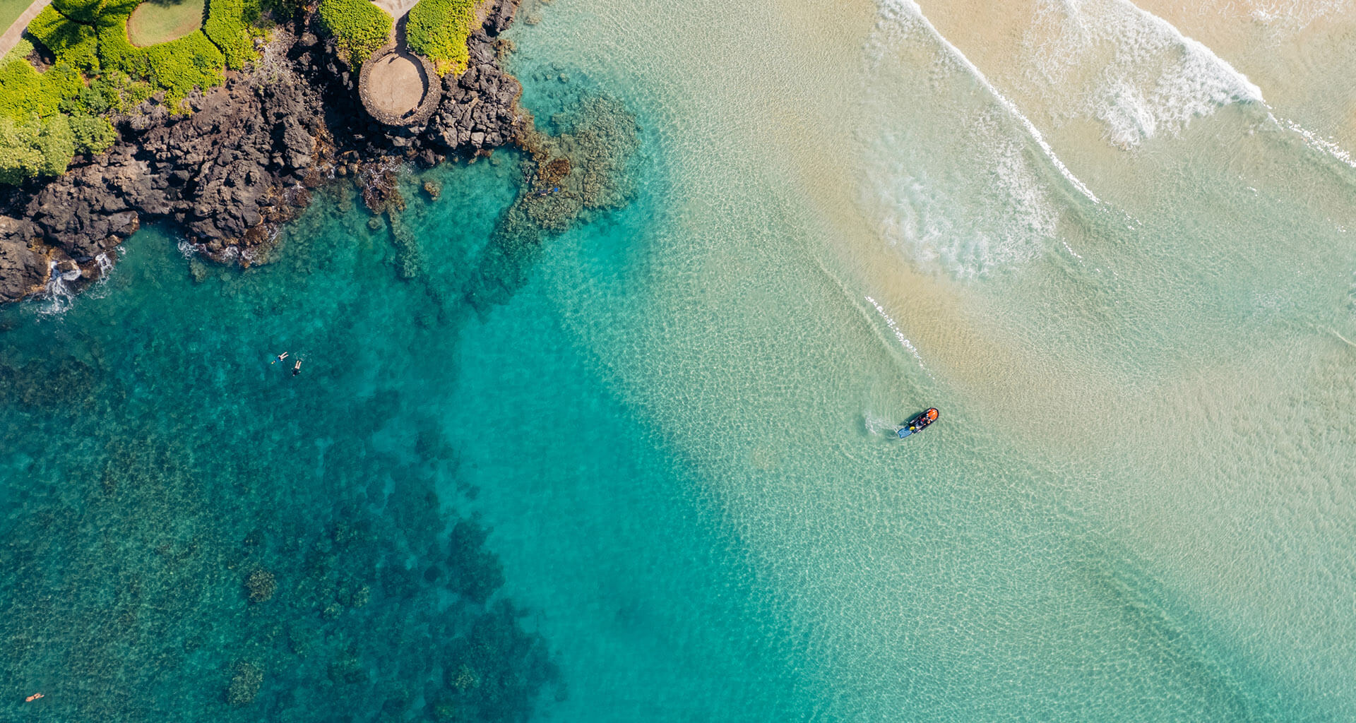 Aerial beach view with people in the water